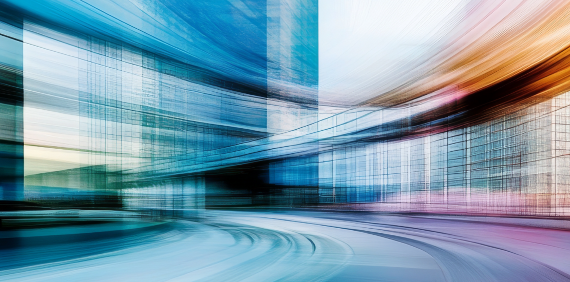 Blurred motion of train near office building.